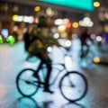 Abstract unrecognizable man silhouette, riding bikes, night city, illumination bokeh, motion blur. Healthy lifestyle Royalty Free Stock Photo