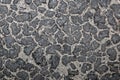 Abstract unusual background of small stones and black blots Royalty Free Stock Photo