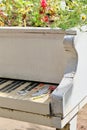 Abstract upright pianos in wood with flowers in the street