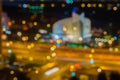 Abstract urban night. City at night with light bokeh, round building or stadium at night. Blurred focus, twilight time Royalty Free Stock Photo