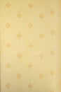 Abstract vertical beige floral pattern on a light yellow wall - fabric, texture, repetitive