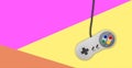 Abstract video gaming controller: Vintage gamepad on colorful background