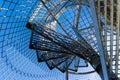 An abstract view of blue sky background and a metal spiral staircase low angle view Royalty Free Stock Photo
