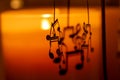 Abstract view of an interior candle lit shelf containing a spinning mobile with musical notes