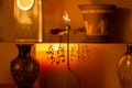 Abstract view of an interior candle lit shelf containing a spinning mobile with musical notes Royalty Free Stock Photo