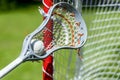 Abstract view of a lacrosse stick scooping up a ball Royalty Free Stock Photo