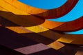Abstract view of modern sculptural architecture with vibrant red and yellow curves.