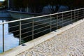 Abstract view of modern stainless steel wire guard rail along pond