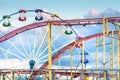 Abstract view of old amusement park with ferris wheel and roller-coaster Royalty Free Stock Photo