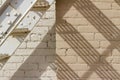 Abstract view of an old gray fire escape staircase in front of a vintage brick wall Royalty Free Stock Photo