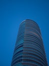 Abstract view on residential apartment complex building with many balconies and floors isolated against blue sky on sunny day Royalty Free Stock Photo