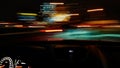 View from the window of a car driving fast along the  street of a night city. Royalty Free Stock Photo