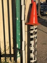 Abstract wall with poles and orange cone