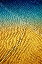 Abstract of water and sand ripples along beach at low tide with Royalty Free Stock Photo