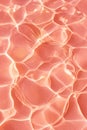 Abstract water surface background with light reflections, showcasing a soft pink hue and fluid textures, creating a Royalty Free Stock Photo