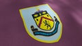 Abstract waving flag with emblem of Burnley football club. Motion. Flags of football clubs in England. For editorial use