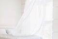 Abstract white bedroom with waving curtains on window Royalty Free Stock Photo