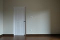 abstract white door close in dark light. sad and alone emotion in empty house. vacancy property white wall background