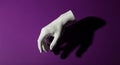 Abstract White Hand Emerging from Purple Surface with Dramatic Shadow Royalty Free Stock Photo