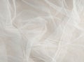 White mosquito net fabric texture with folds. Wavy chiffon background. Full frame of crumpled white cloth material texture. Royalty Free Stock Photo