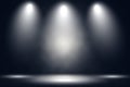 White stage with spot lighting and fog in black background.