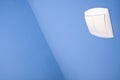 Abstract wide angle light switch on blue wall Royalty Free Stock Photo