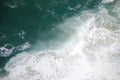 Abstract wild coast line with crashing waves shot from above. Royalty Free Stock Photo