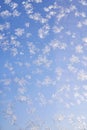 Abstract winter background. Frost on a frozen window against the blue sky. Royalty Free Stock Photo