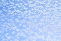 Abstract winter background. Frost on a frozen window against the blue sky. Royalty Free Stock Photo