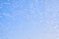 Abstract winter background. Frost on a frozen window against the blue sky. Royalty Free Stock Photo