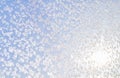 Abstract winter background. Frost on a frozen window against the blue sky. Royalty Free Stock Photo