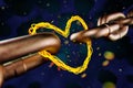 Abstract wiring of a hot coil in the form of a metal chain connected by a heart. Royalty Free Stock Photo