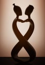 Abstract Wooden Man and Wooman in Love Statue with backlight over Wall. 3d Rendering