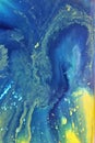 Abstract yellow-blue marble background. The lines and waves of acrylic paint create an interesting structure. Royalty Free Stock Photo