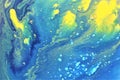 Abstract yellow-blue marble background. The lines and waves of acrylic paint create an interesting structure. Royalty Free Stock Photo