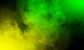 Abstract yellow and green smoke mist fog on a black background.