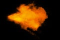 Abstract yellow orange powder explosion on black background. Freeze motion of yellow orange dust particles splash Royalty Free Stock Photo