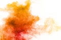 Abstract yellow orange powder explosion on white background.Freeze motion of yellow  orange dust particles splash Royalty Free Stock Photo