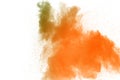 Abstract yellow orange powder explosion on white background. Freeze motion of yellow orange dust particles splash Royalty Free Stock Photo