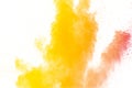 Abstract yellow orange powder explosion on white background. Freeze motion of yellow orange dust particles splash Royalty Free Stock Photo