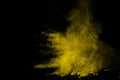 Abstract of yellow powder explosion on black background. Yellow powder splatted isolate. Colored cloud. Colored dust explode. Pain Royalty Free Stock Photo