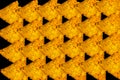 Abstract yellow triangular nachos on black backround Royalty Free Stock Photo