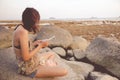 Abstract Young woman in casual style fashion siting on the beach Royalty Free Stock Photo