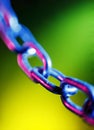 Abstracted short depth of field image of chain links, on a colourful background