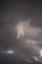 Abstraction of a electricity man from a wire in front of a stormy cloudy sky. Concept Royalty Free Stock Photo