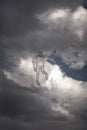 Abstraction of a electricity man from a wire in front of a stormy cloudy sky. Concept Royalty Free Stock Photo