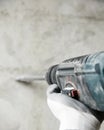 Abstraction photo of noisy repair. electric tool in the hands of a construction worker, gadder against a concrete wall Royalty Free Stock Photo