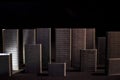 Abstraction A simulated city created from staples forming skyscrapers with a dark background and shadow. Blurry dark city