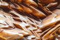 Abstraction of a wooden smooth uneven surface of a beautiful brown color with an orange tint with smooth curves and shadows