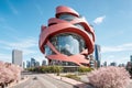 absurd building skyscraper in donut shape in the city, Organic modernist architecture illustration Ai Generated